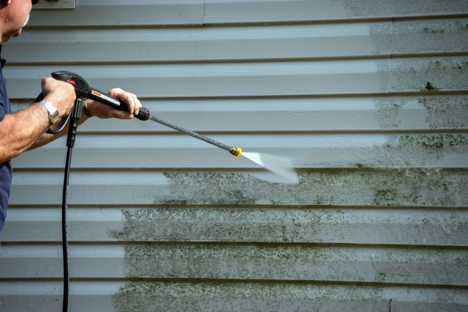 A professional soft washing exterior siding